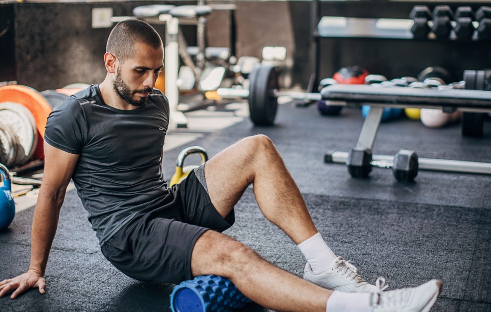 one young man using a foam roller