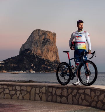 a man on a bicycle with ocean behind him