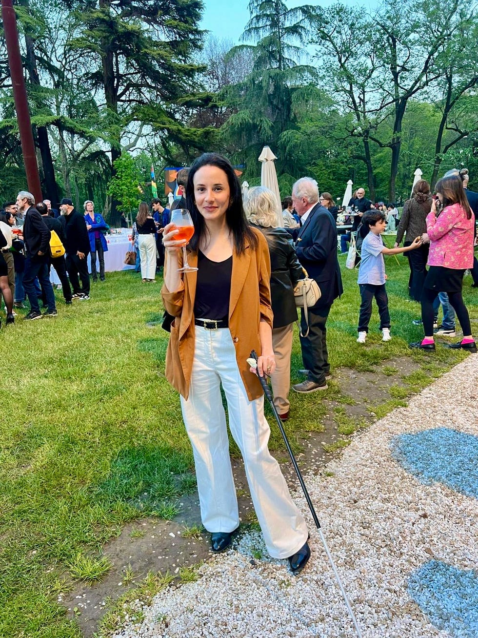 a person walking on a path with a crowd of people