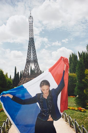 a person holding a flag in front of a tower