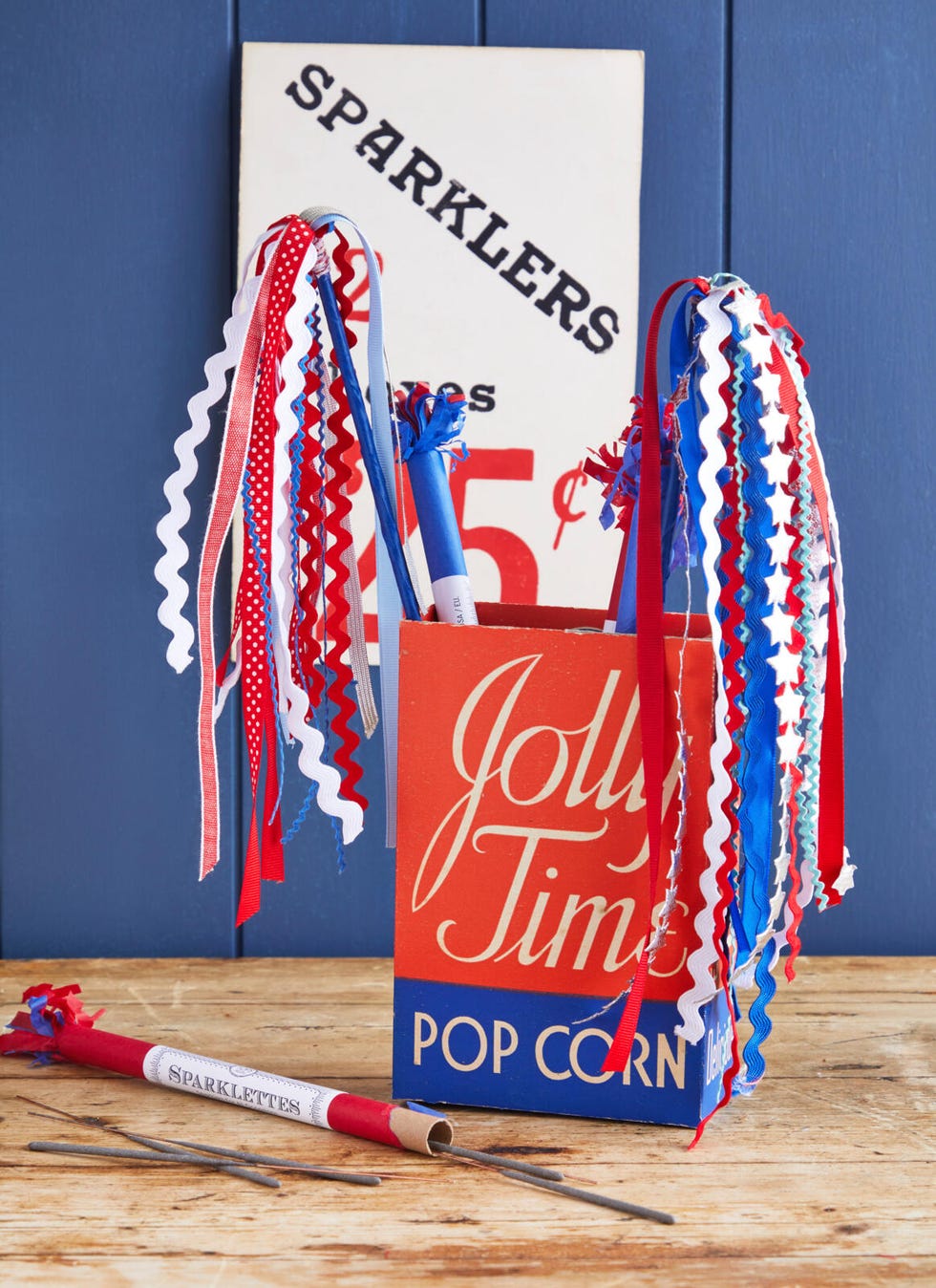 sparklers made from ribbon and rick rack in an empty vintage jolly time pop corn box