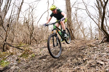 a person riding a bike on a trail in the woods