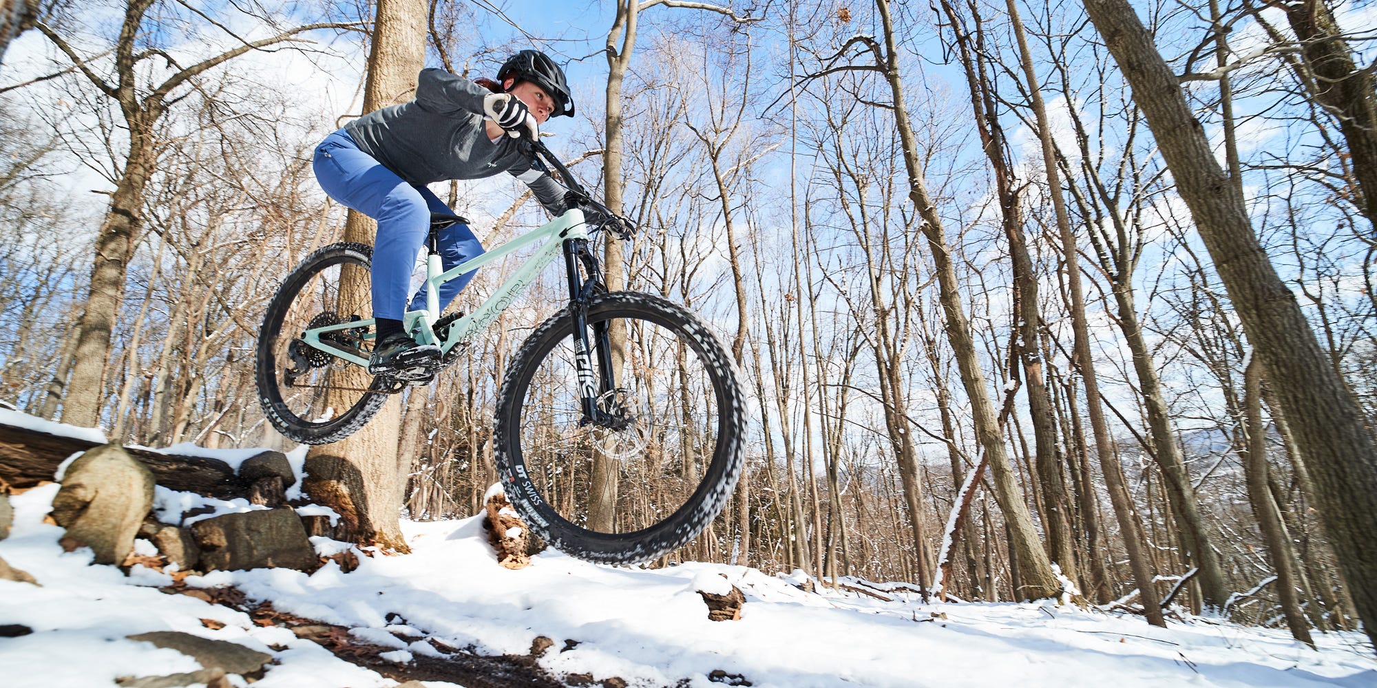 a person riding a bike in the snow