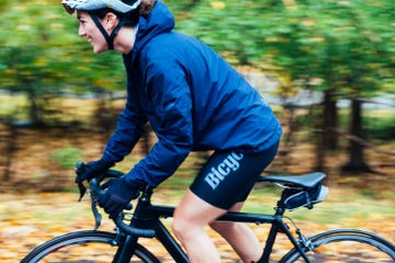 a woman riding a bicycle smiling