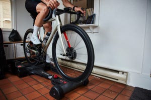 a cyclist riding rollers inside