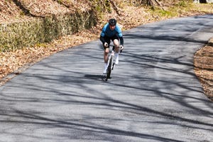 a person riding a bike down a road fast