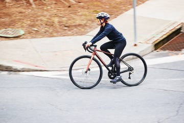 cycling tips a person riding a bicycle on a road around a corner