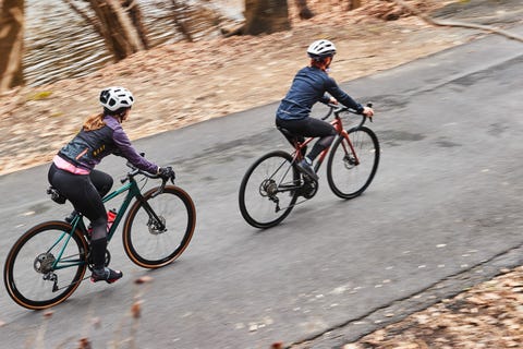 two people riding road bikes up a climb