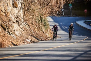 two women riding up a hill together