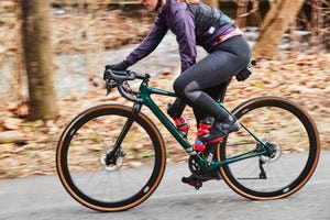 grabbing a water bottle from the bottle cage on a bike while riding