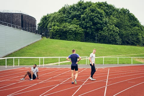 runners resting on running track