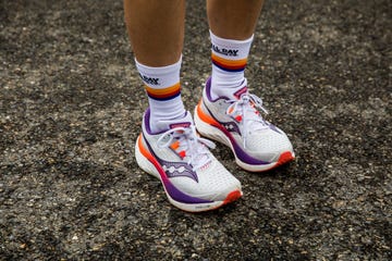 a person wearing saucony endorphin speed 4 cushioned running shoes