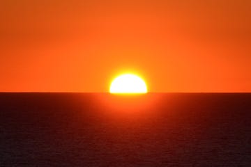 scenic view of sea against orange sky,lissabon,portugal