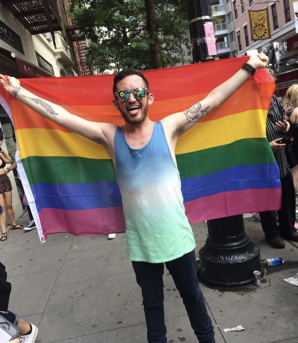 sean holding a pride flag