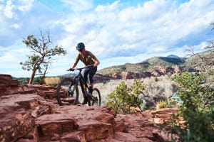 a man riding a bike on a rocky terrain