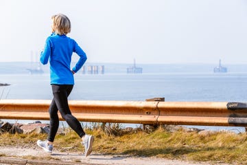 senior woman jogging, cromarty firth, scotland