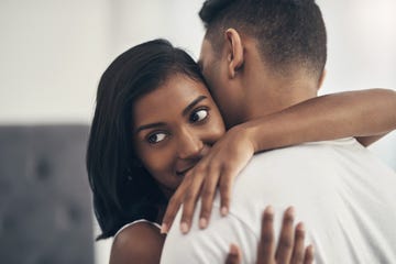 shot of a young couple hugging at home