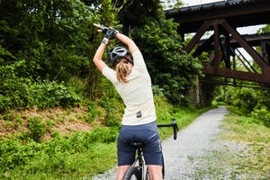 woman stretching on bike