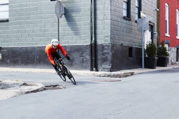 a person riding a bicycle around a corner