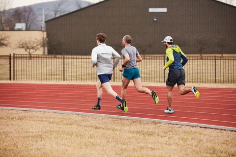 a group of men running on a track