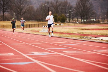 a runner running fast on a track
