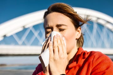 sporty woman sneezes during jog