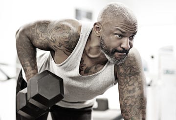 Tattooed middle aged bearded black man at a gym