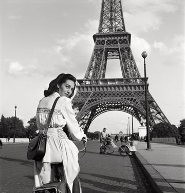 parisian woman in front of the eiffel tower 1945