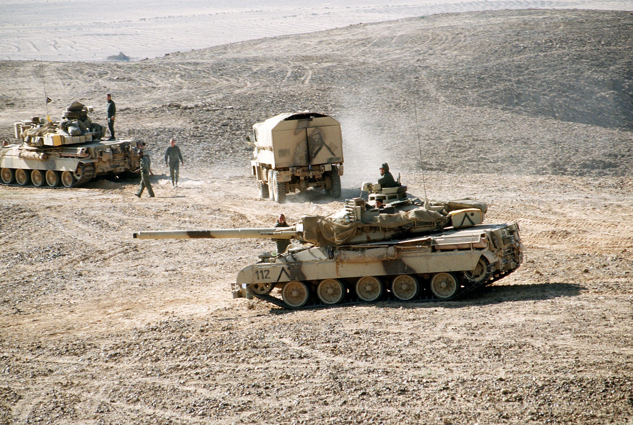 a pair of amx 30 main battle tanks and a truck of the french 6th light armored division pause outside al salman during operation desert storm