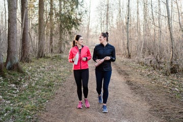 two friends talking and walking after workout