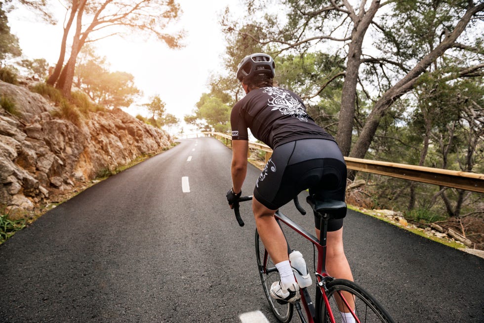 woman cycling on country road