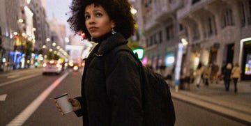 a woman walking in city at night