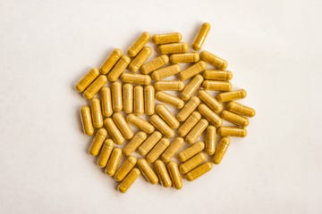 yellow color pills capsules on white background