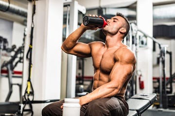 young man drinking his proteins at the gym