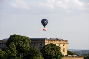 A hot air balloon over a city skyline, with text that reads "NHS waiting lists: Sky high" on it