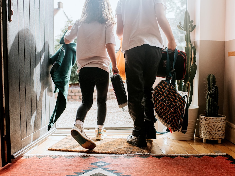 PHOTO: Stock photo of two kids leaving a home. 