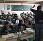 FILE - In this Sept. 18, 2015 file photo, students follow a Tibetan-language lesson at the Lhasa-Beijing Experimental Middle School on the outskirts of Lhasa, capital of the Tibet Autonomous Region in China. An official Chinese Communist Party newspaper says Tibetan children have been banned from taking part in religious activities over the summer 2018 school holidays. (AP Photo/Aritz Parra, File)