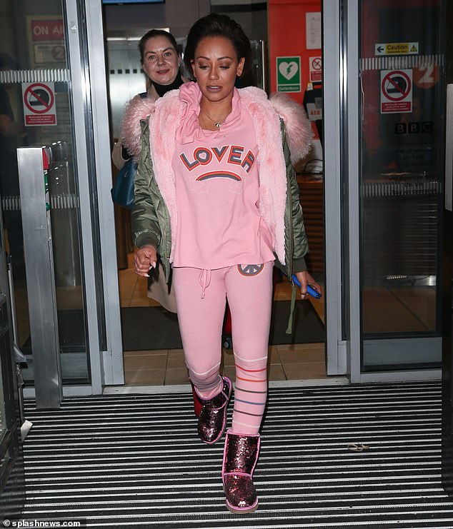 In the pink... Mel B proved she can wear many hats as she headed out in London on Saturday to promote her autobiography, Brutally Honest