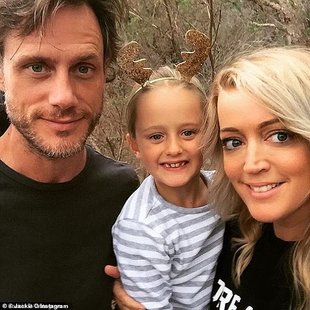 New beginnings: Jackie, 43, officially split with her British photographer husband Lee Henderson (pictured) in October this year. The couple are pictured with their daughter Catalina, AKA 'Kitty', seven