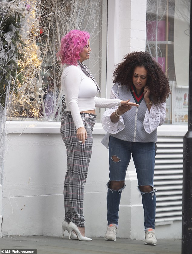 Gal pals: Also looking stylish for the outing, Danielle teamed distressed jeans with a grey vest and a cream blouse with flared sleeves