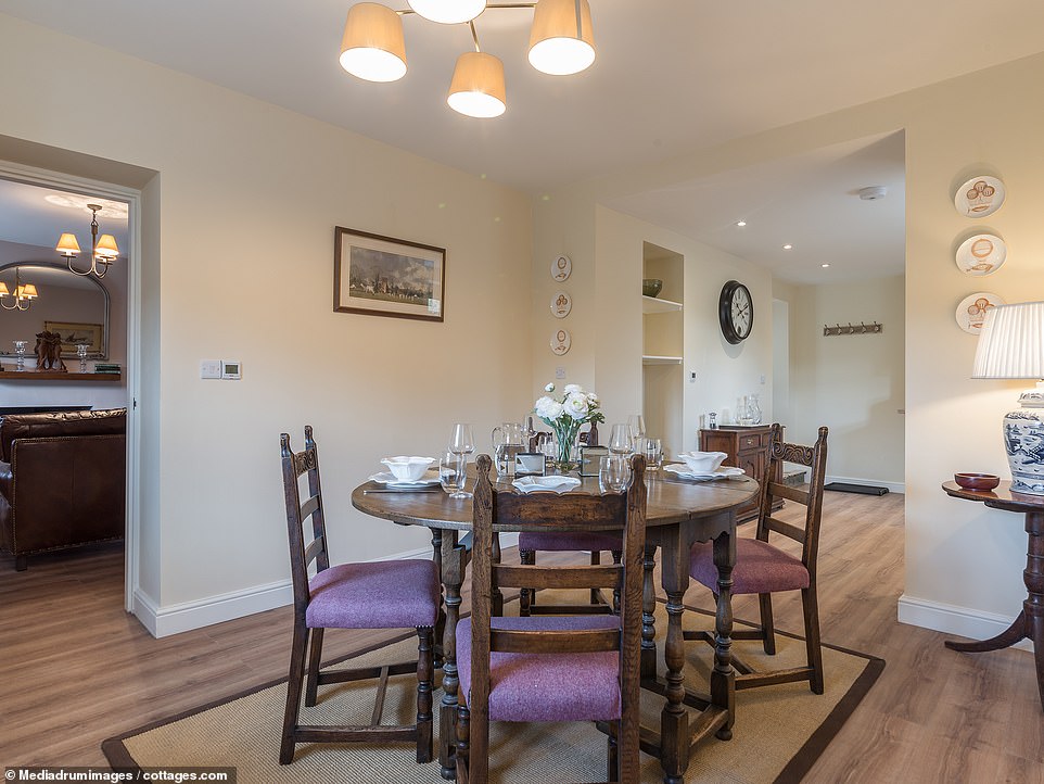 There is ample space for guests to entertain and eat dinner in the cottage's dining room, pictured 