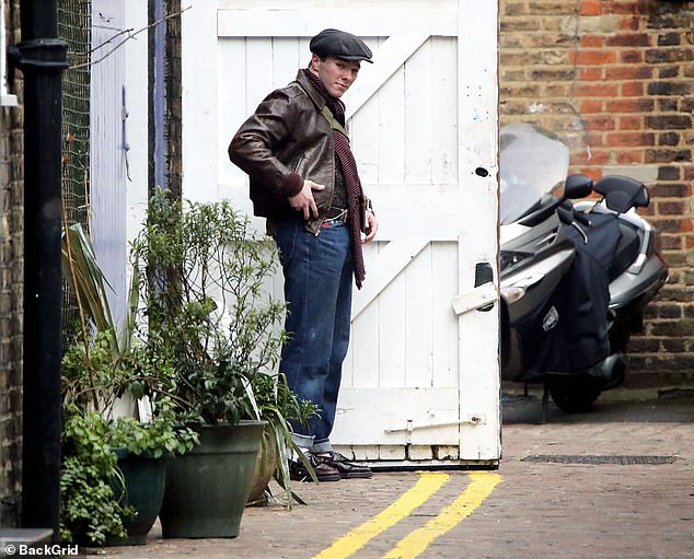 Out and about: Rocco Ritchie put on a dapper display as he went for a bike ride around London on Friday, wrapping up against the freezing weather in a brown leather jacket