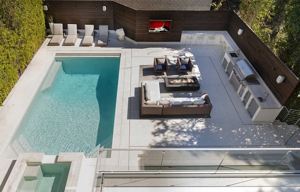 Pictured: Highlights of the home included an outdoor swimming pool, home gym, cinema room, six bathrooms and impressive panoramic views of downtown Los Angeles