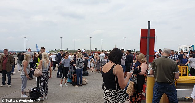 Crowds of people were pictured on the tarmac near the runway outside, while others were stuck on planes