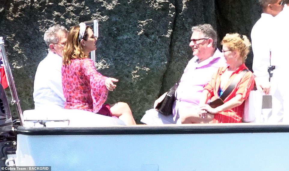 Chatty: The pair looked in  great spirits as they chatted with friends on a boat