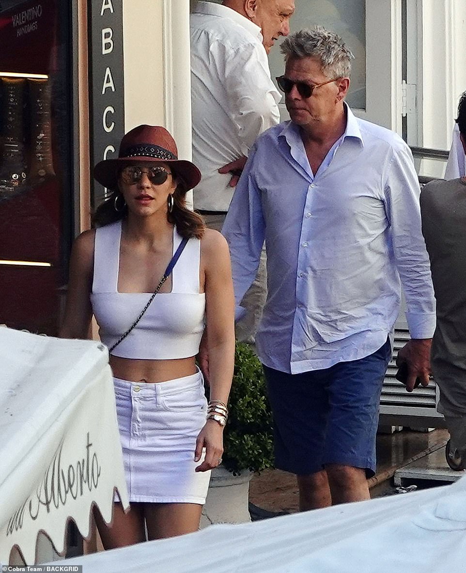 Summer chic: The singer looked sensational as she showed off her toned stomach in a white crop top, which she teamed with a matching miniskirt for the romantic excursion with her music producer other half