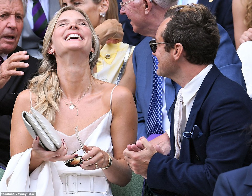 Newlywedded bliss: Dr Phillipa Coan and Jude Law, who married in May, giggled as they took in the action at Wimbledon