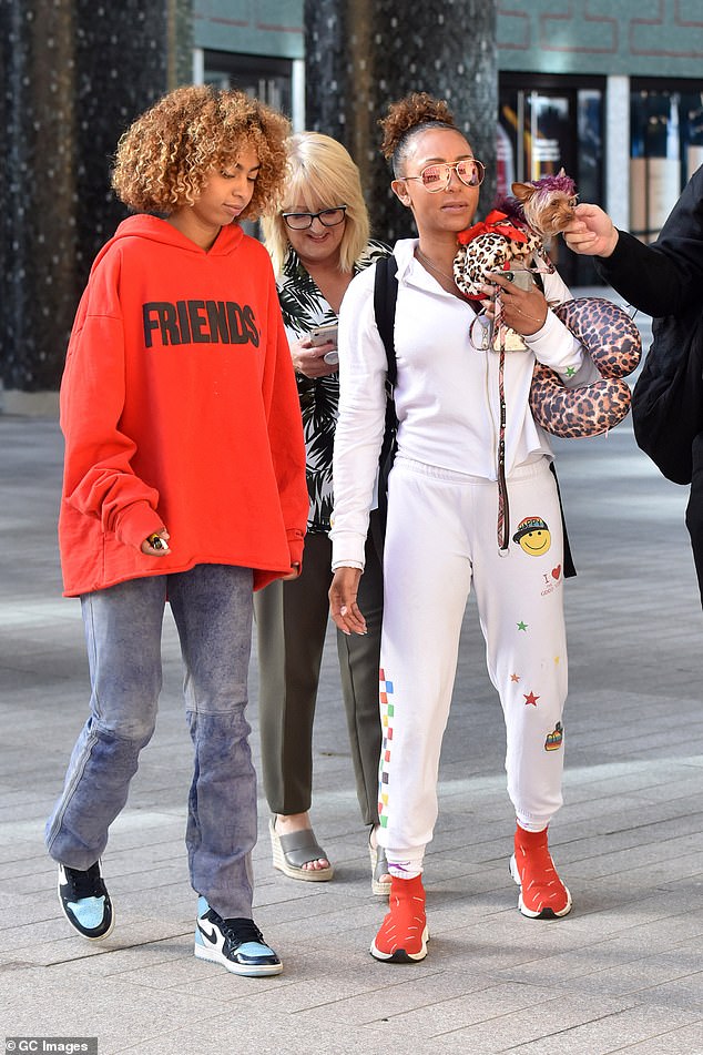 Casual chic: Mel wore a white top with jogging bottoms, which had a colourful print on it