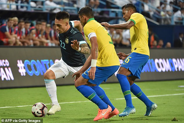 Lautaro Martinez (left) is watched carefully by Brazil captain Thiago Silva and Alex Sandro