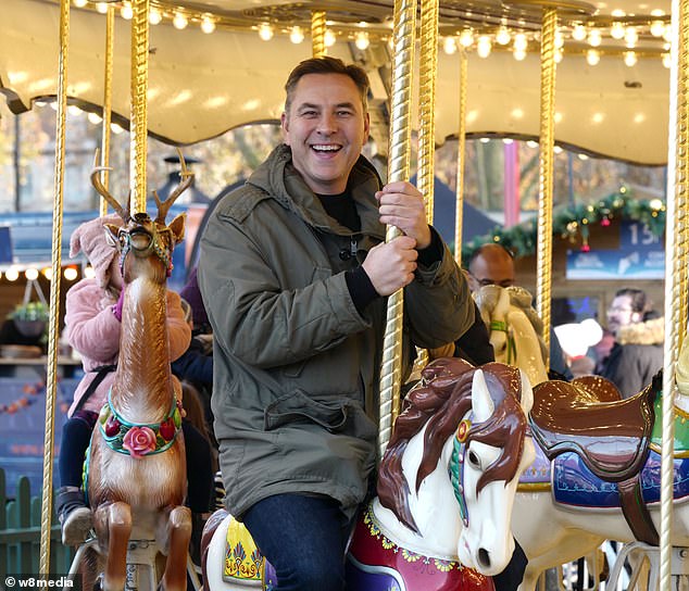 Letting loose: He couldn't contain his happiness as he embarked on a carousel ride